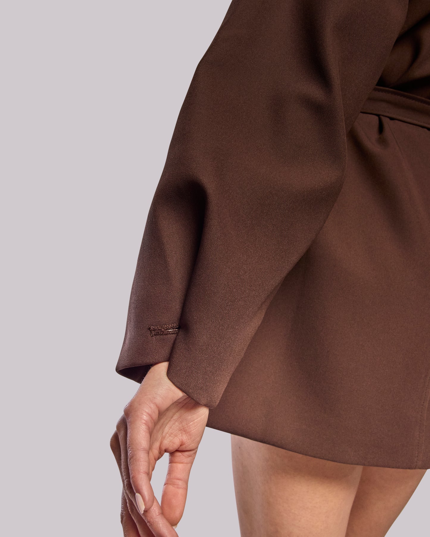 Model wearing Dawn brown wrap coat showing fabric