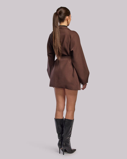 Model wearing Dawn brown wrap coat standing back angle