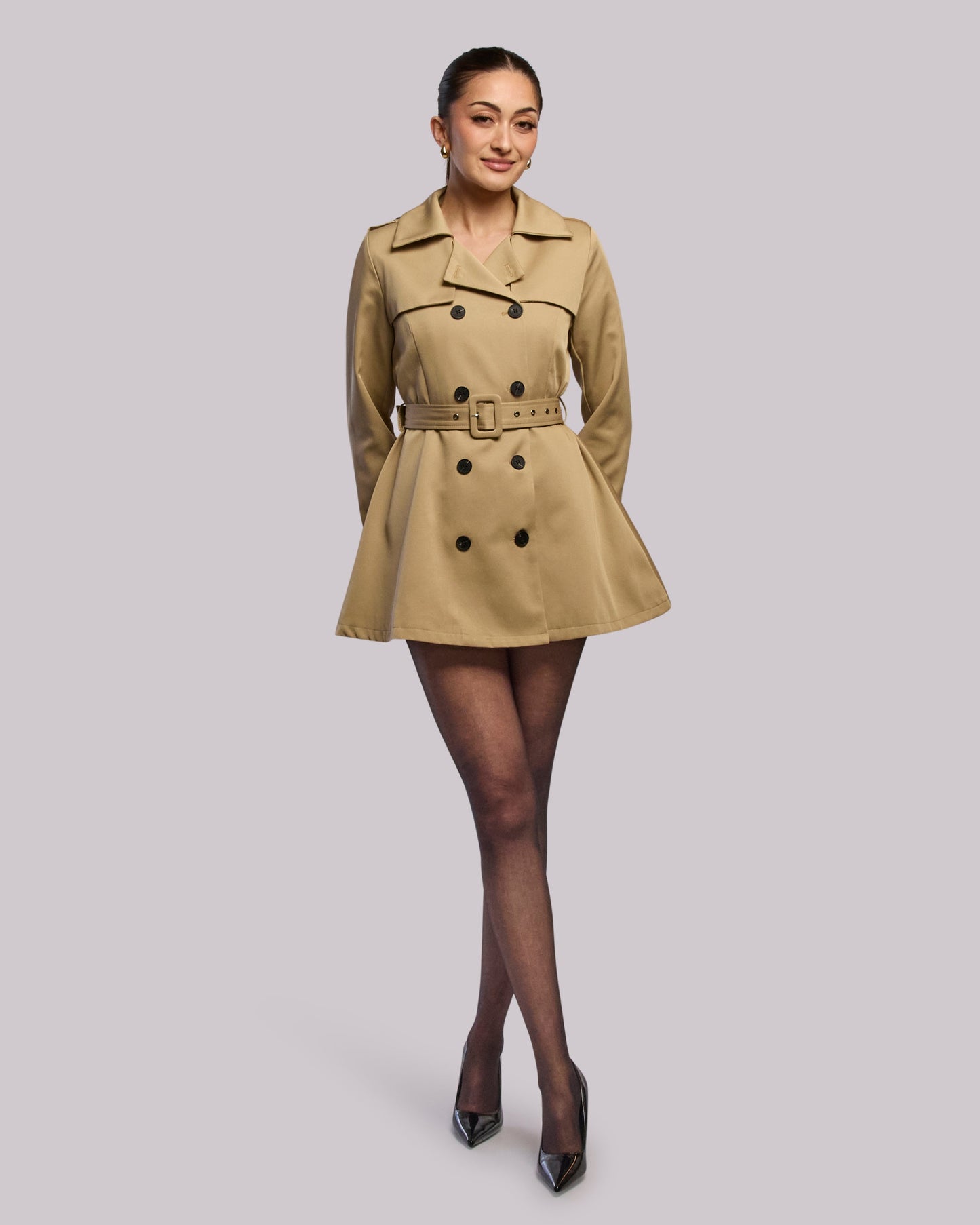 Model wearing Diva short trench coat standing straight