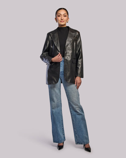 Model wearing Moon oversized blazer and jeans standing straight
