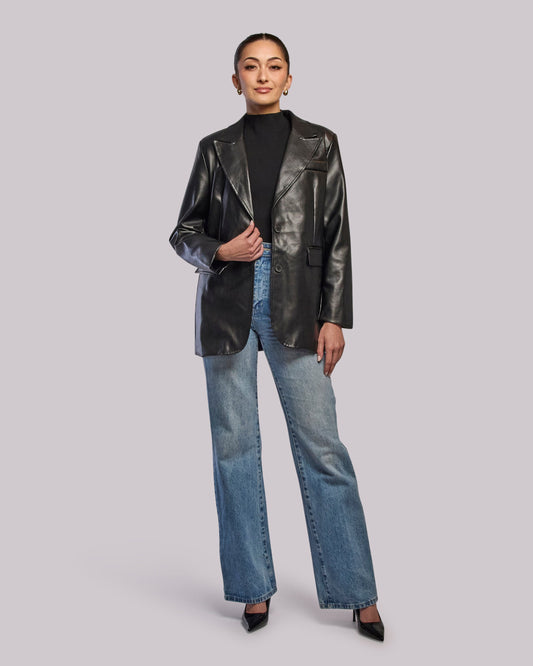 Model wearing Moon oversized blazer and jeans standing straight