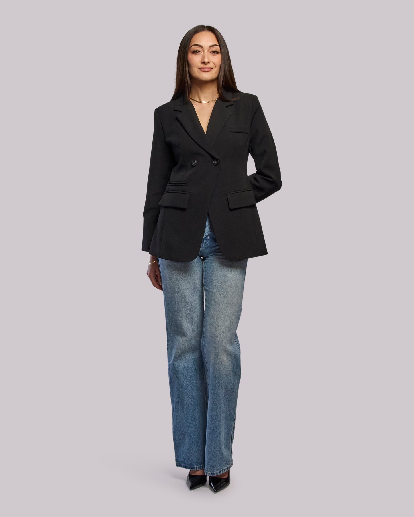Model wearing Roar blazer with jeans hands at back