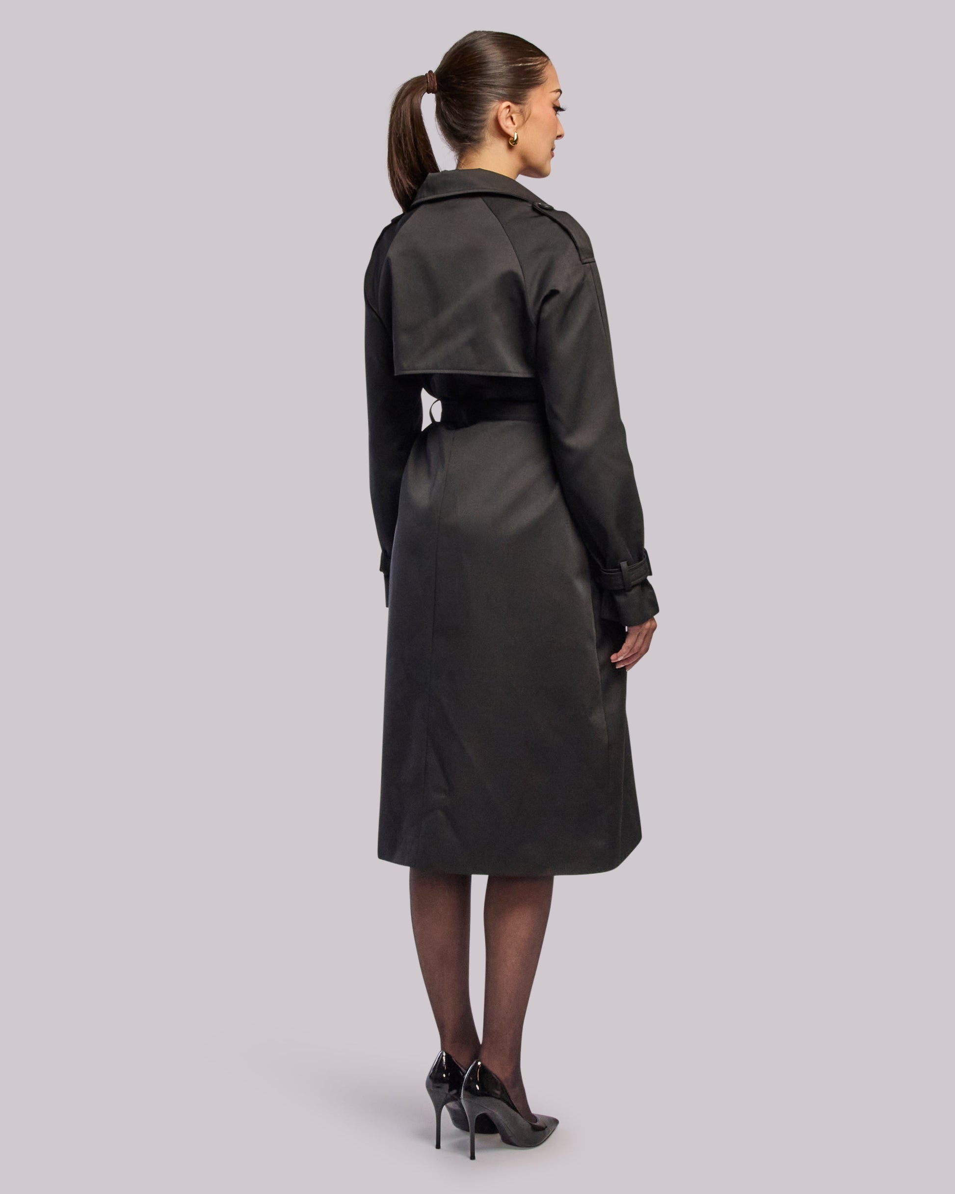 Model wearing Victory black trench coat standing back angle