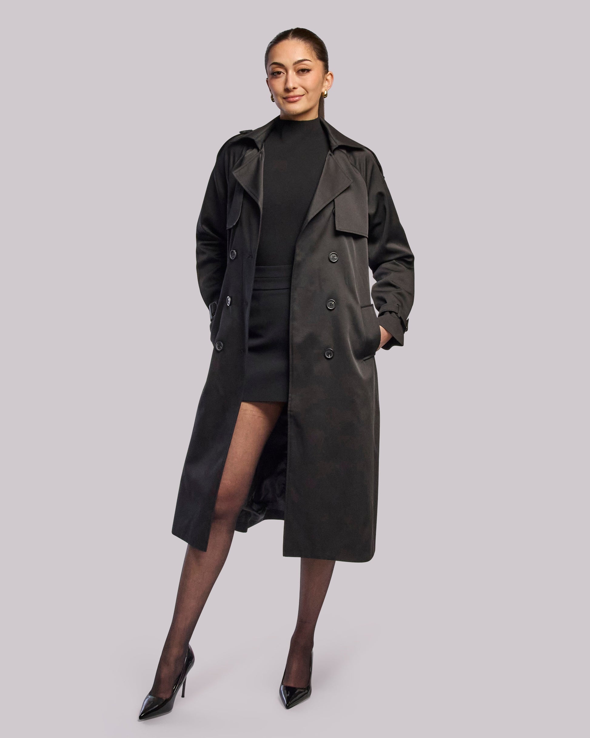 Model wearing Victory black trench coat standing straight with hands in pocket